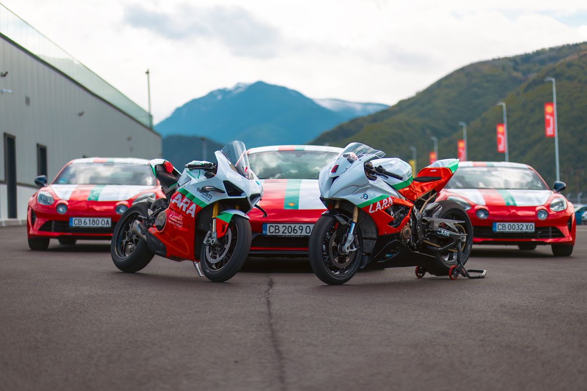 Lara Racing Team: bikes and cars, mountains behind