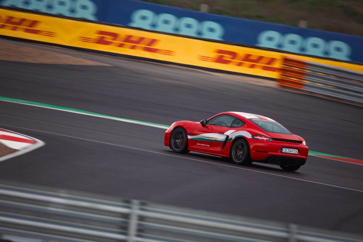 Cayman at speed past the DHL boards